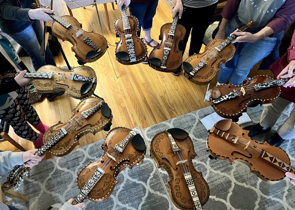 ten hardanger fiddles held in a circle